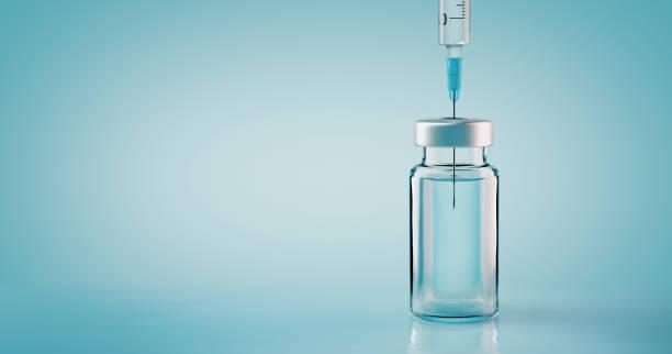 Stock photo of a syringe in a vial with clear liquid